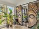 Inviting sunroom with decorative doors and large windows, filled with natural light and lush plants at 197 Sawmill Ln, Idaho Springs, CO 80452