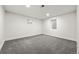 This is an empty basement bedroom or living area with carpet and two small windows at 3565 S Holly St, Denver, CO 80237