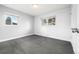 This bedroom has two windows, a closet and grey carpet, with neutral color walls and trim at 3565 S Holly St, Denver, CO 80237