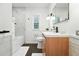 Updated bathroom featuring a wood vanity, white marble shower, and modern fixtures at 1731 Locust St, Denver, CO 80220