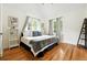 A spacious bedroom with hardwood floors, neutral decor, and plenty of natural light from the windows at 1731 Locust St, Denver, CO 80220
