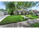 A charming home with a lush green lawn, mature trees, and well-maintained landscaping, enhancing curb appeal at 1731 Locust St, Denver, CO 80220