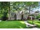 Charming stone home with well-manicured lawn and mature trees at 1731 Locust St, Denver, CO 80220