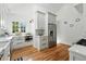 Modern kitchen featuring sleek cabinetry, stainless steel appliances, granite countertops and hardwood floors with ample natural light at 1731 Locust St, Denver, CO 80220