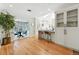 The bright kitchen has hardwood floors, white cabinets, modern appliances, an island with bar seating, and an attached dining area at 1731 Locust St, Denver, CO 80220