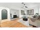 Inviting living room featuring hardwood floors, arched doorways, and a decorative fireplace with natural light from large windows at 1731 Locust St, Denver, CO 80220