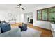 The stylish living room has hardwood floors, ample natural light and a view to the fireplace through the arched entryway at 1731 Locust St, Denver, CO 80220