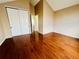 Spacious bedroom featuring vaulted ceilings, hardwood flooring, and a large closet, offering comfort and ample storage space at 4111 E 94Th Ave # E, Thornton, CO 80229