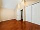 Sunny bedroom with high vaulted ceilings, wood-look floors, and a double door closet at 4111 E 94Th Ave # E, Thornton, CO 80229