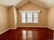 Cozy bedroom featuring a bay window, vaulted ceiling, and wood flooring providing natural light and a peaceful ambiance at 4111 E 94Th Ave # E, Thornton, CO 80229