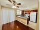 Eat-in kitchen with granite countertops, tile backsplash, stainless refrigerator, ceiling fan, and sliding doors at 4111 E 94Th Ave # E, Thornton, CO 80229