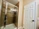 Tiled shower with a glass door and modern fixtures inside the primary bathroom at 4111 E 94Th Ave # E, Thornton, CO 80229
