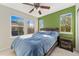Bedroom with ceiling fan, two windows and green accent wall at 9478 E 108Th Ave, Commerce City, CO 80640