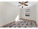 A cozy bedroom with a window offering natural light, with a ceiling fan for added comfort at 9478 E 108Th Ave, Commerce City, CO 80640