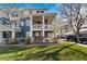 Charming two-story townhome featuring a welcoming blue exterior and landscaped front yard at 9478 E 108Th Ave, Commerce City, CO 80640