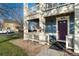 Close-up of a townhome entrance featuring a covered porch and stylish purple door at 9478 E 108Th Ave, Commerce City, CO 80640