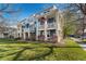 Inviting two-story townhome featuring a charming blue exterior and a welcoming front porch with an American flag at 9478 E 108Th Ave, Commerce City, CO 80640