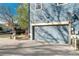 Attached two-car garage with a concrete driveway and adjacent landscaping at 9478 E 108Th Ave, Commerce City, CO 80640