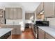Functional kitchen with neutral cabinets, tiled floors, and stainless steel oven at 9478 E 108Th Ave, Commerce City, CO 80640