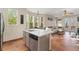 Bright kitchen features large windows, center island, stainless steel dishwasher, and terra cotta tile floor at 9478 E 108Th Ave, Commerce City, CO 80640