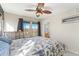 Sunlit bedroom features a ceiling fan, a side table and scenic views from the windows at 9478 E 108Th Ave, Commerce City, CO 80640