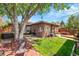 Serene backyard with a lush lawn, brick patio, and inviting outdoor seating area at 2901 Monaco Pkwy, Denver, CO 80207