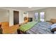 Bright bedroom featuring hardwood floors, a walk-in closet, and French doors to a private yard at 2901 Monaco Pkwy, Denver, CO 80207