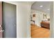 Welcoming entryway with hardwood floors, arched doorway, and seamless flow to the living room at 2901 Monaco Pkwy, Denver, CO 80207