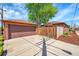 Spacious home featuring a detached garage, expansive driveway and manicured lawn at 2901 Monaco Pkwy, Denver, CO 80207