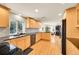 Modern kitchen with updated appliances, granite countertops, hardwood floors, and open layout at 2901 Monaco Pkwy, Denver, CO 80207