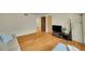 Spacious living room with hardwood floors, a comfortable sofa, and a dark entertainment center at 2901 Monaco Pkwy, Denver, CO 80207