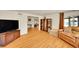Spacious living room with hardwood floors, neutral decor, and open doorway at 2901 Monaco Pkwy, Denver, CO 80207