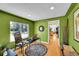 Bright office with modern decor, large window, hardwood floor and open doorway at 2901 Monaco Pkwy, Denver, CO 80207