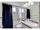 Functional bathroom with a shower and bathtub combination, featuring a blue curtain at 11183 E 114Th Ave, Commerce City, CO 80640