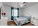 Cozy bedroom featuring a ceiling fan, white furniture, and natural light from the window at 11183 E 114Th Ave, Commerce City, CO 80640