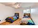 Bright bedroom with two twin beds, themed bedding, and a ceiling fan at 11183 E 114Th Ave, Commerce City, CO 80640