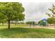 Community park showcasing a grassy area, playground, swingset, picnic shelter, and mature trees at 11183 E 114Th Ave, Commerce City, CO 80640