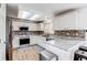 Bright kitchen features white cabinetry, stainless steel appliances, and stylish backsplash at 11183 E 114Th Ave, Commerce City, CO 80640