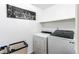 Functional laundry room featuring a washer, dryer, and modern art at 11183 E 114Th Ave, Commerce City, CO 80640