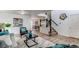 Bright living room featuring modern decor, hardwood floors, and an open staircase leading to the upper level at 11183 E 114Th Ave, Commerce City, CO 80640