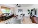 Comfortable living room with a cozy sofa, stylish chairs, and ample natural light, perfect for relaxing at 11183 E 114Th Ave, Commerce City, CO 80640