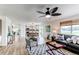 Open-concept living area with modern furnishings, bright lighting, and seamless flow to the dining area and kitchen at 11183 E 114Th Ave, Commerce City, CO 80640