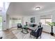 Spacious living room with large windows, comfortable seating, and stylish decor, perfect for relaxation and entertaining at 11183 E 114Th Ave, Commerce City, CO 80640