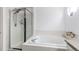 Bright main bathroom featuring a glass enclosed shower and separate tub at 11183 E 114Th Ave, Commerce City, CO 80640