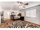 Spacious main bedroom featuring neutral carpet, large windows, and elegant dark wood furniture at 11183 E 114Th Ave, Commerce City, CO 80640