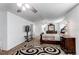 Spacious main bedroom featuring neutral carpet, large windows, and elegant dark wood furniture at 11183 E 114Th Ave, Commerce City, CO 80640