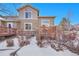 Exterior view of home with a deck and stone pillars in a partially snow-covered yard at 22029 E Irish Dr, Aurora, CO 80016