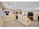 Spacious basement with a seating area, mini fridge, and football decor at 22029 E Irish Dr, Aurora, CO 80016