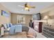 Cozy bedroom with fireplace, ceiling fan, and a window view at 22029 E Irish Dr, Aurora, CO 80016