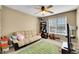 Cozy bedroom with a futon, football themed rug, and a ceiling fan at 22029 E Irish Dr, Aurora, CO 80016